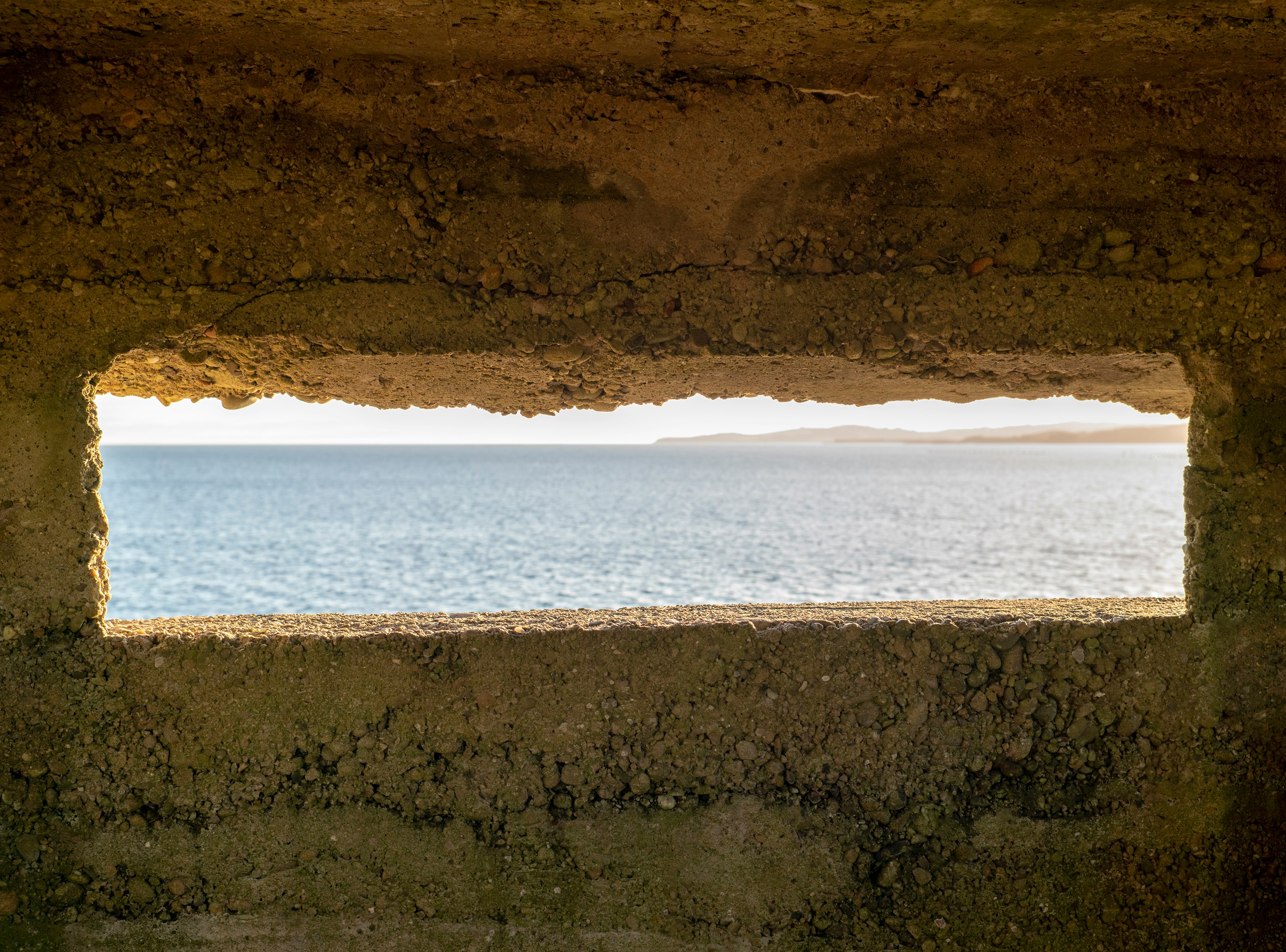 brown rock formation near body of water during daytime